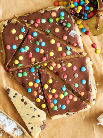 A slab of cookie dough bark cut into triangles.