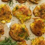 Baked smashed potatoes on a baking sheet.