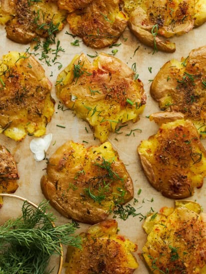 Baked smashed potatoes on a baking sheet.