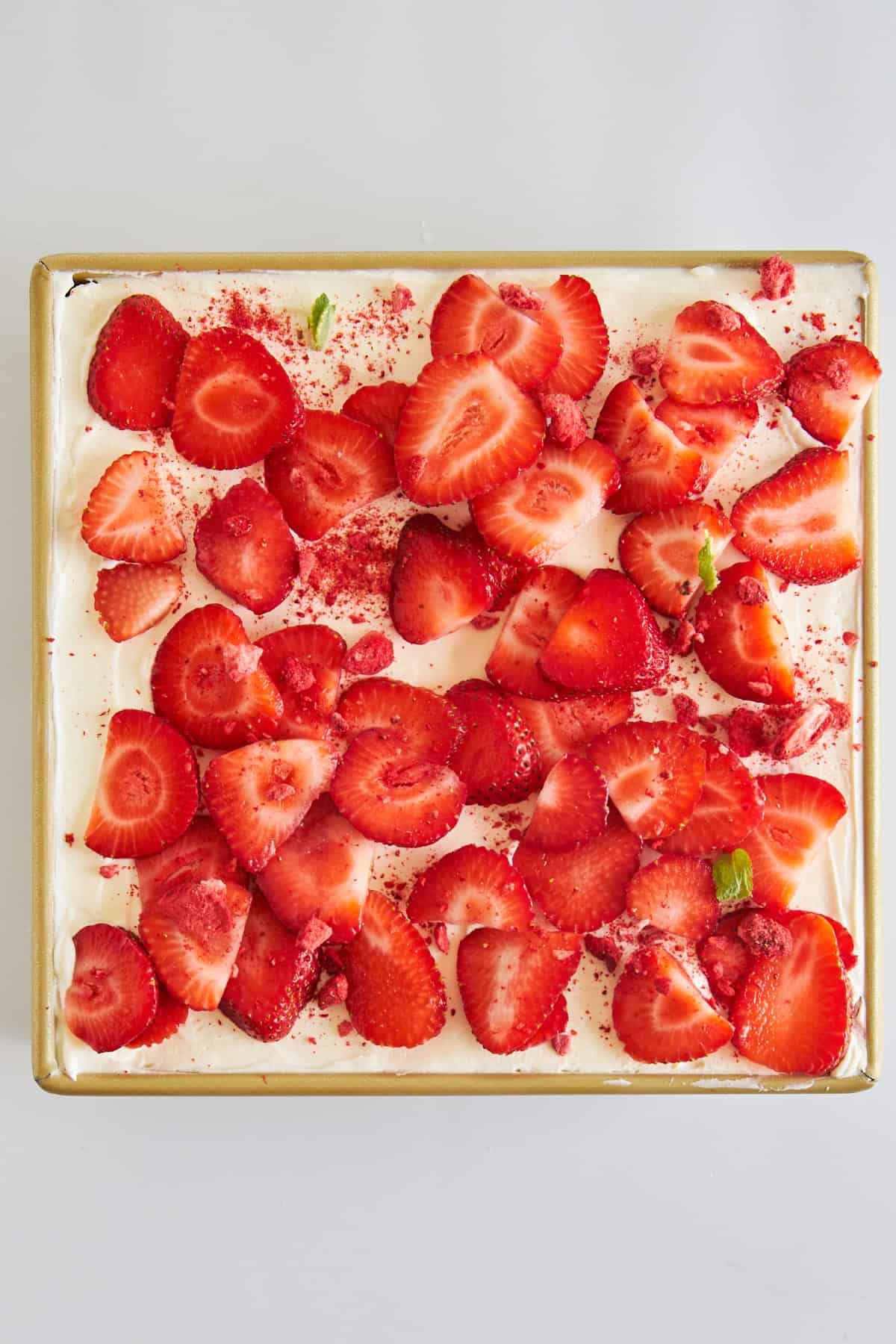 Overhead image of strawberry tiramisu topped with strawberries. 