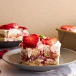 Slices of strawberry tiramisu on plates.