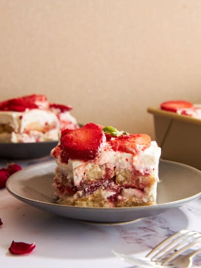 Slices of strawberry tiramisu on plates.