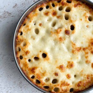 Overhead image of a honeycomb pasta cake in a circular dish.