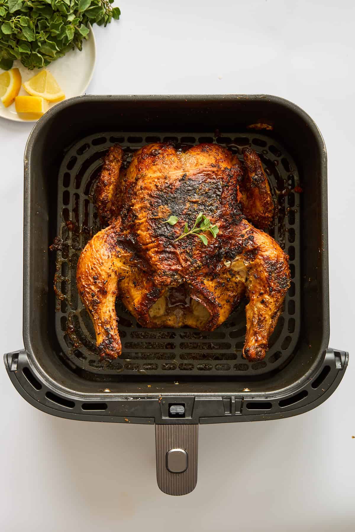 A whole chicken in an air fryer.