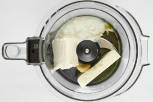 Whipped feta ingredients in a food processor.