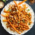 A plate of chickpeas and roasted carrots with whipped feta.