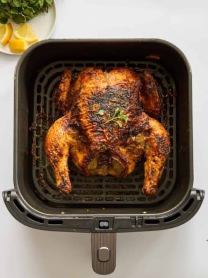 A whole chicken in an air fryer.