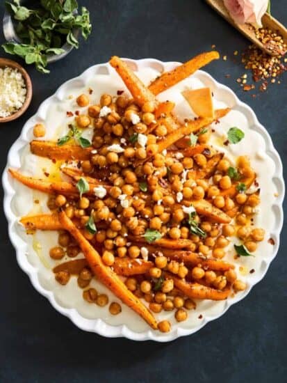 A plate of chickpeas and roasted carrots with whipped feta.