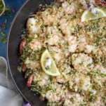 easy baked shrimp scampi skillet topped with lemon wedges