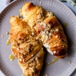 two cinnamon crisp apple french toast bake croissants on a plate