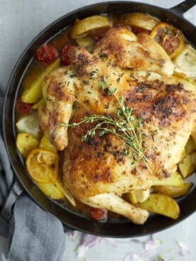 overhead of roasted chicken and vegetables in a pan