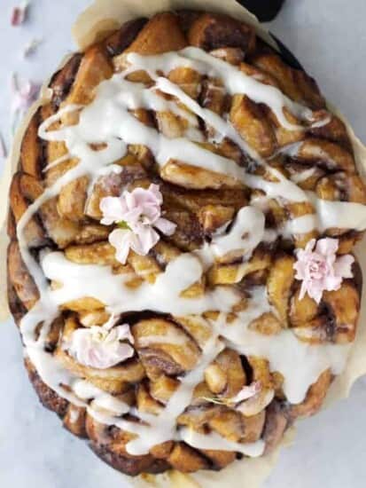 overhead image of slow cooker apple cinnamon rolls topped with a drizzle of icing