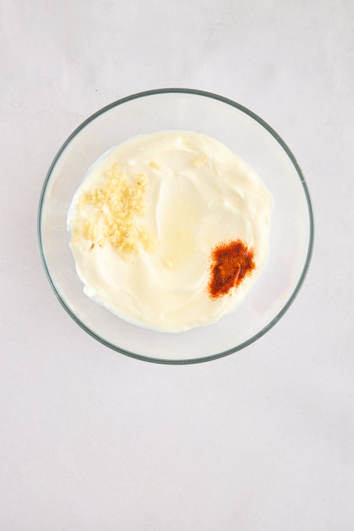 Garlic, yogurt, and spices in a bowl. 