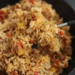 a spoonful of stuffed pepper rice bake being lifted from a casserole dish