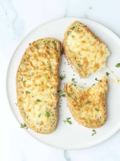 overhead of 2 slices of cheese toast on a plate