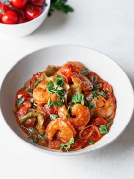 overhead of shrimp and tomato sauce on a plate