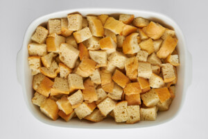 Bread cubes in a baking dish.