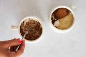 Dry ingredients for a chocolate mug cake being whisked.