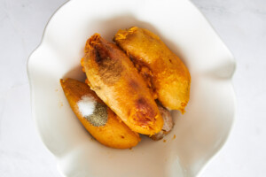 Peeled baked sweet potatoes in a bowl.