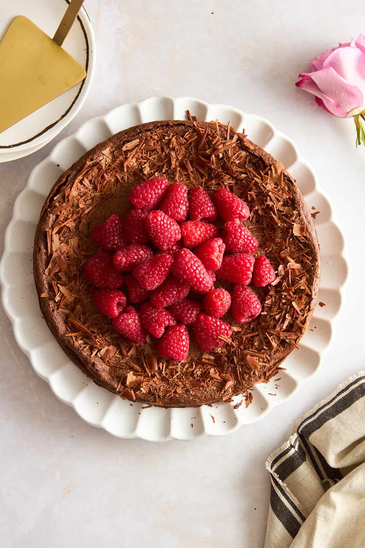 Overhead image of a flourless chocolate cake topped with raspberries.