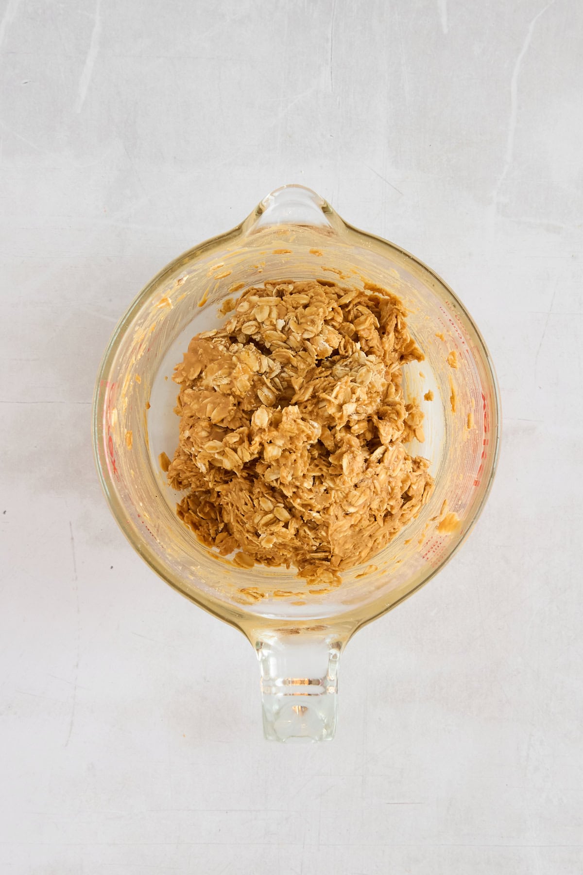 Granola cup batter in a glass measuring cup. 