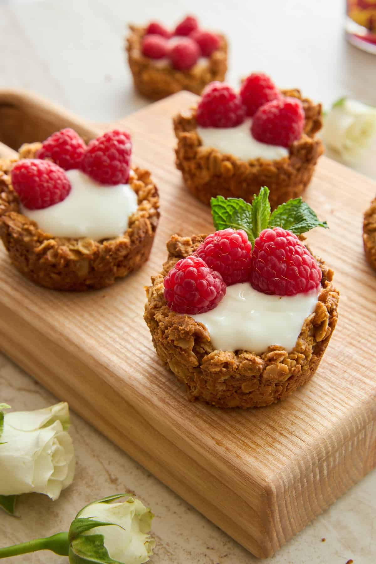 Yogurt Filled Granola Cups topped with fresh raspberries. 