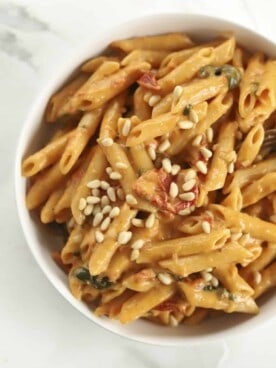 bowl of sun dried tomato pasta with pine nuts