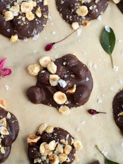 a close up image of a piece of hazelnut chocolate crock pot candy on parchment paper