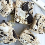 6 Oreo Rice Krispie Treats topped with white chocolate chips and Oreo chunks