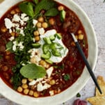 a bowl of Middle Eastern beef chili with a spoon dipped in