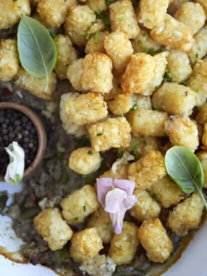 close up image of a tater tot hotdish recipe with a serving taken out