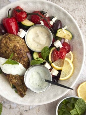 overhead image of a bowl of za'atar chicken with vegetables.