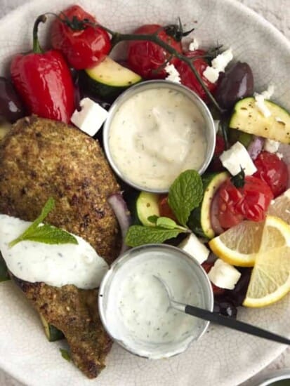 overhead image of a bowl of za'atar chicken with vegetables.