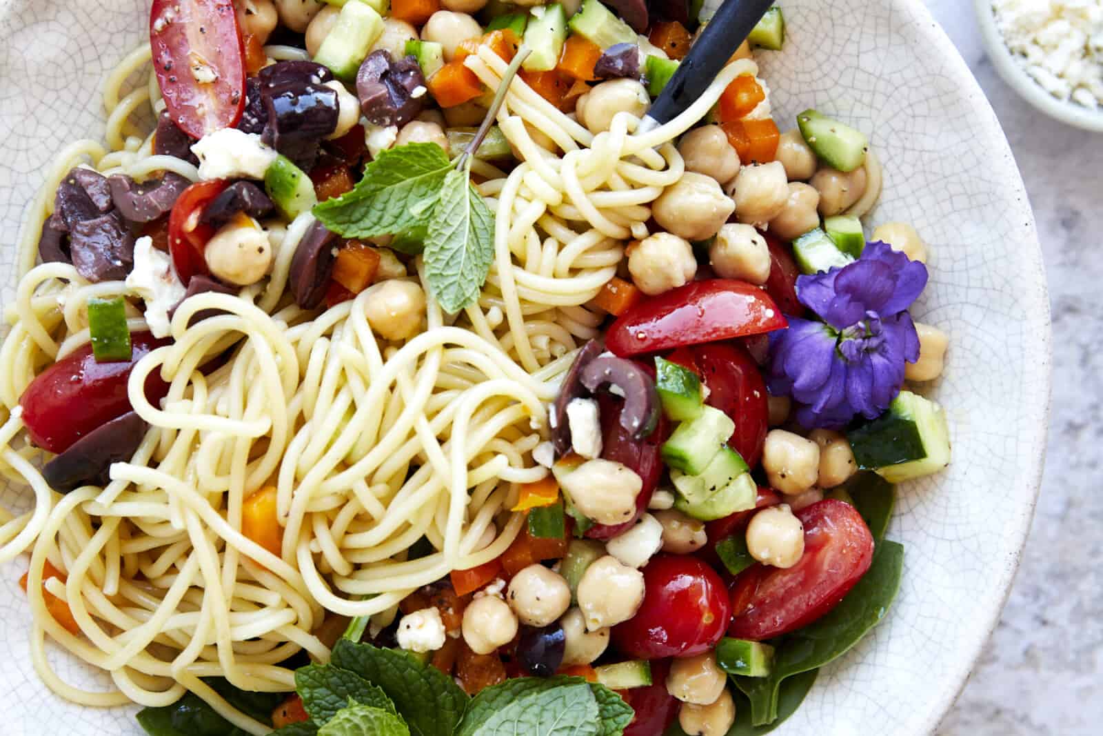 https://www.fooddolls.com/wp-content/uploads/2023/04/Greek-Spaghetti-Salad15754-1600x1067.jpg
