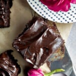 A square of chocolate zucchini cake topped with chocolate frosting.