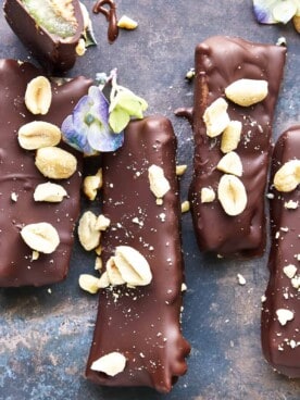 Chocolate dipped celery and peanut butter logs topped with peanuts and sea salt.