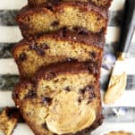 Chocolate chip peanut butter banana bread with peanut butter smeared over the top piece.