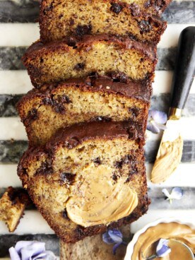 Chocolate chip peanut butter banana bread with peanut butter smeared over the top piece.