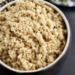 A bowl of fluffy, cooked quinoa.