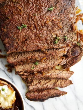 Cooked beef brisket with a few pieces sliced.