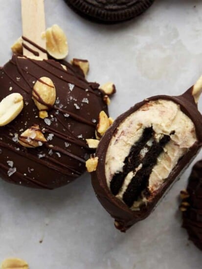 Peanut butter Oreo yogurt popsicles topped with peanuts and salt.