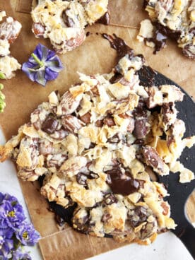 A spatula scooping up a slab of coconut chocolate almond bark.