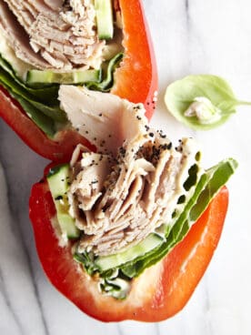 Two halves of a sliced low-carb turkey bell pepper sandwich.