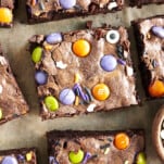 Square Halloween brownies with M&Ms, sprinkles, and eyeballs.