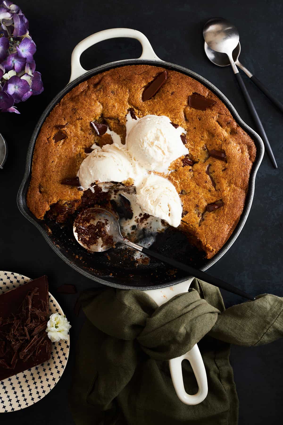 Skillet chocolate chip cookie recipe topped with vanilla ice cream.