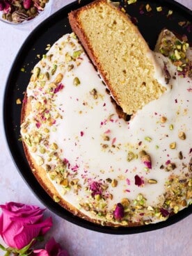 Persian love cake with a piece on its side.