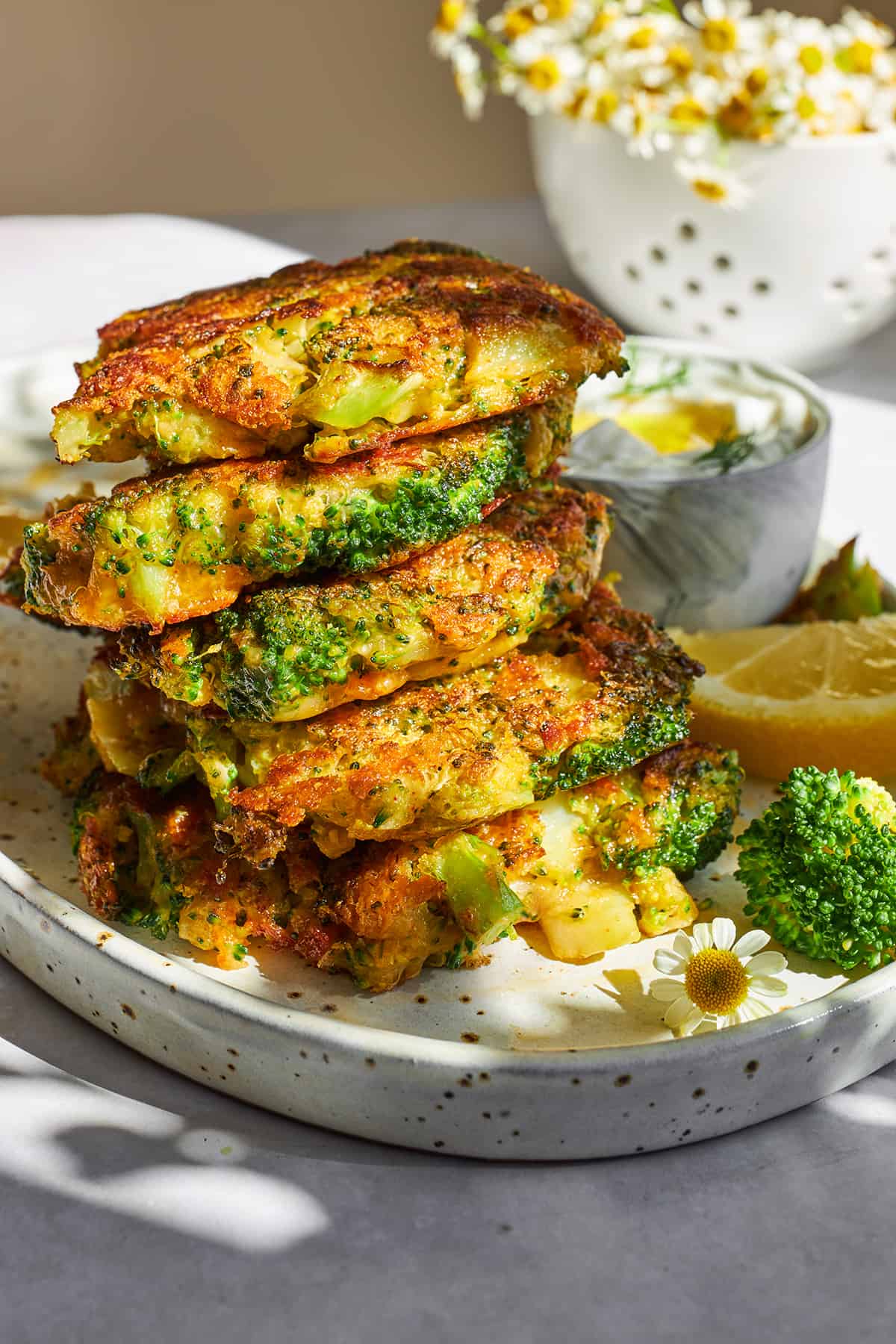 A stack of five cheesy broccoli fritters.
