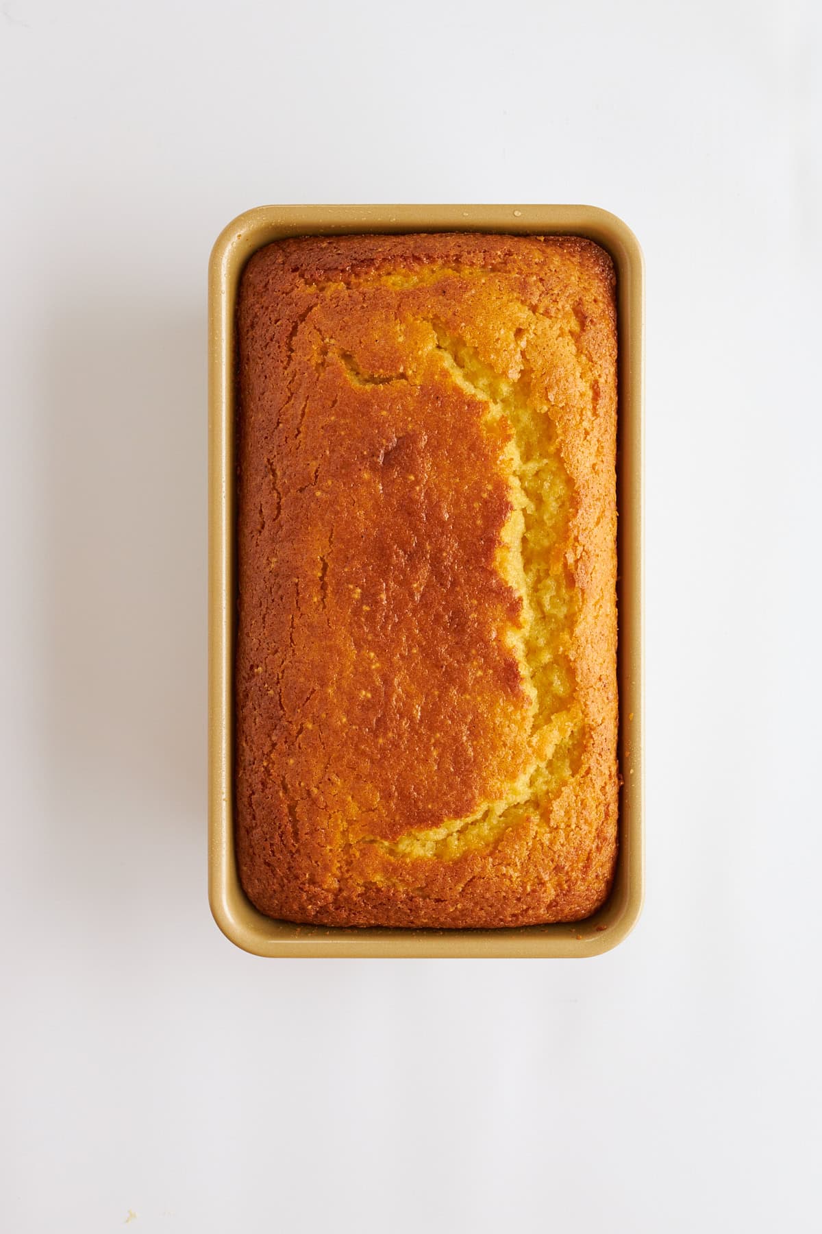 Overhead image of lemon bread in a loaf pan. 