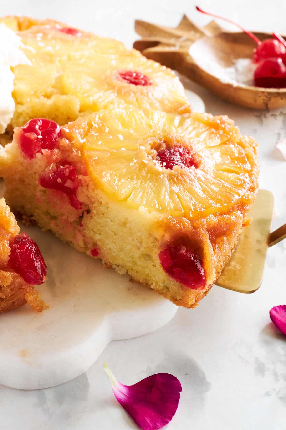 Close up image of a slice of pineapple upside down cake being lifted. 