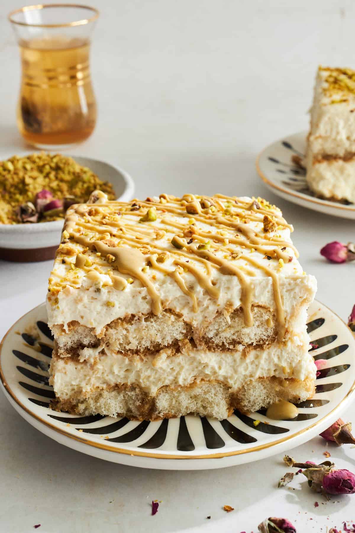 A slice of pistachio tiramisu on a plate. 